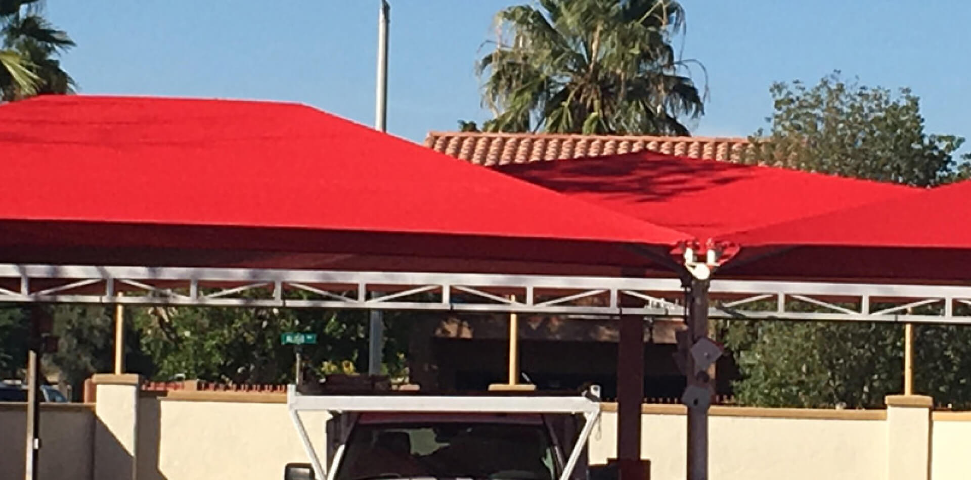 Red fabric canopy covering an automotive service lane