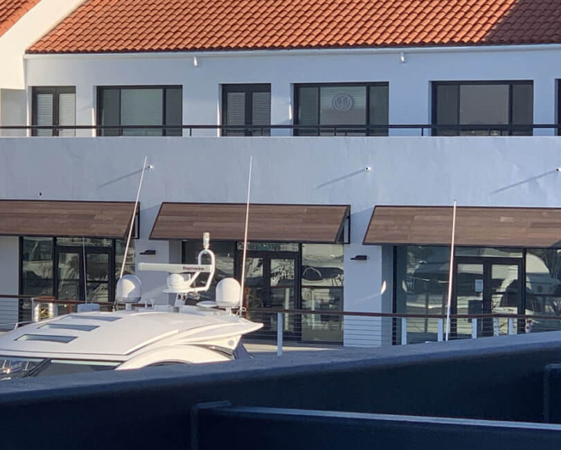 Wood-finish metal awnings above waterfront storefronts, Orange County