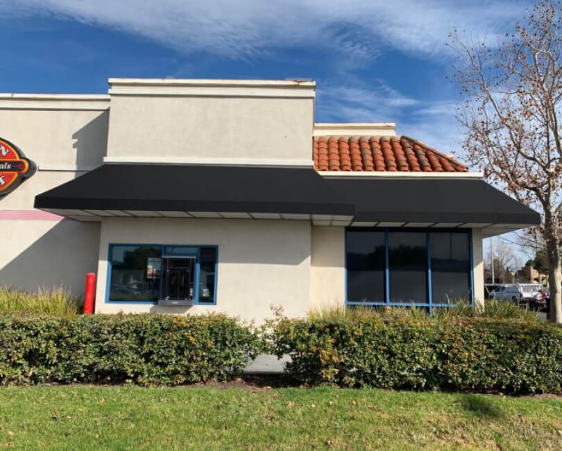 Black fixed canvas awnings on a restaurant building, Los Angeles