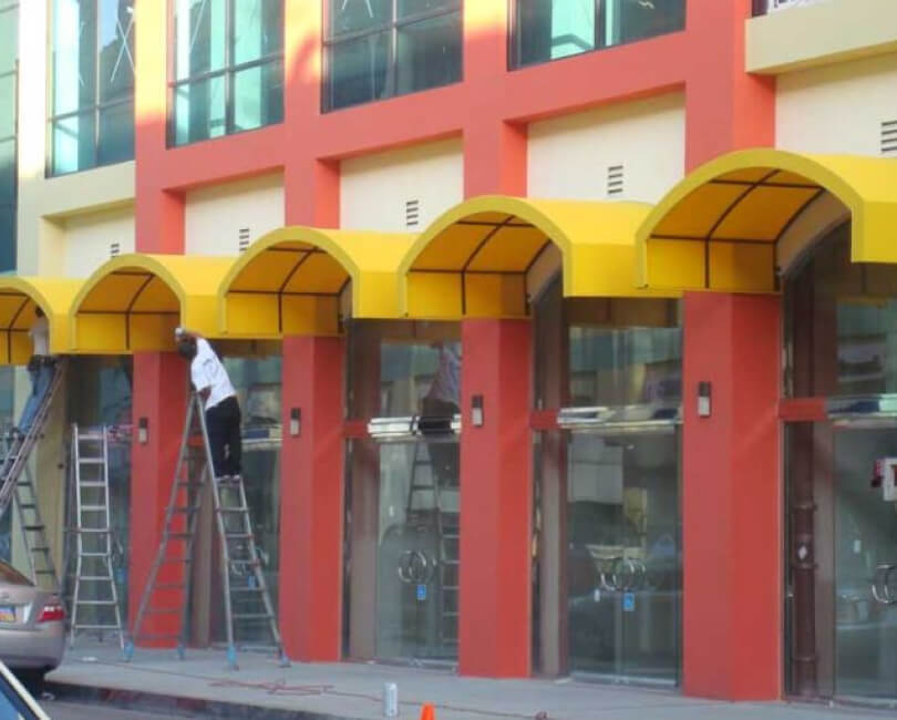 Yellow arched fabric awnings above storefront windows, Ventura County