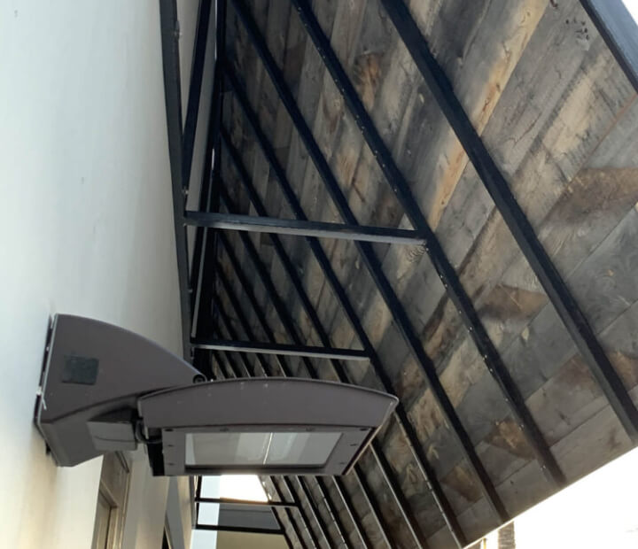 Steel support frame beneath a metal awning, Orange County