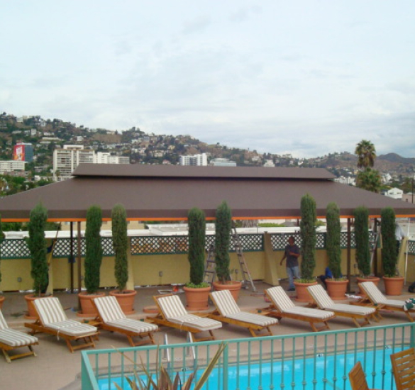 Long cabana structure behind pool deck chairs, Ventura County