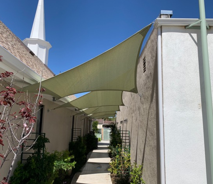 Green shade sails covering a narrow courtyard, Riverside County