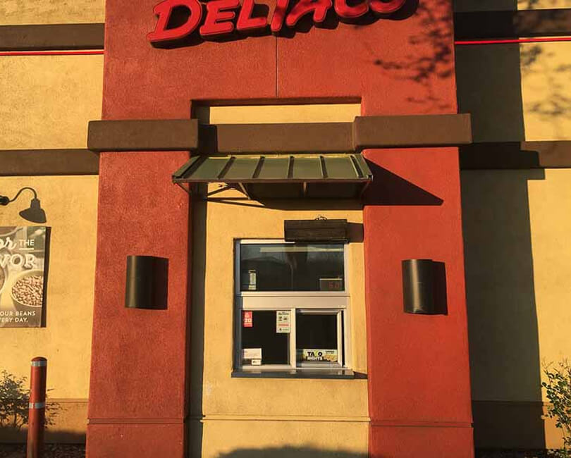 Metal awning above a commercial service window, Ventura County