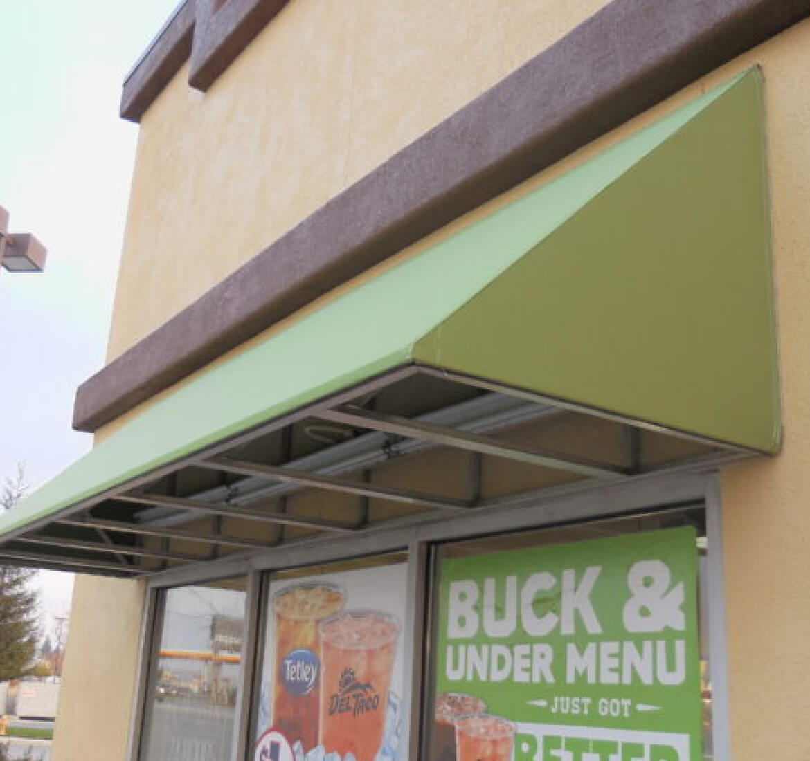 Green fixed canvas awning above a storefront, Los Angeles