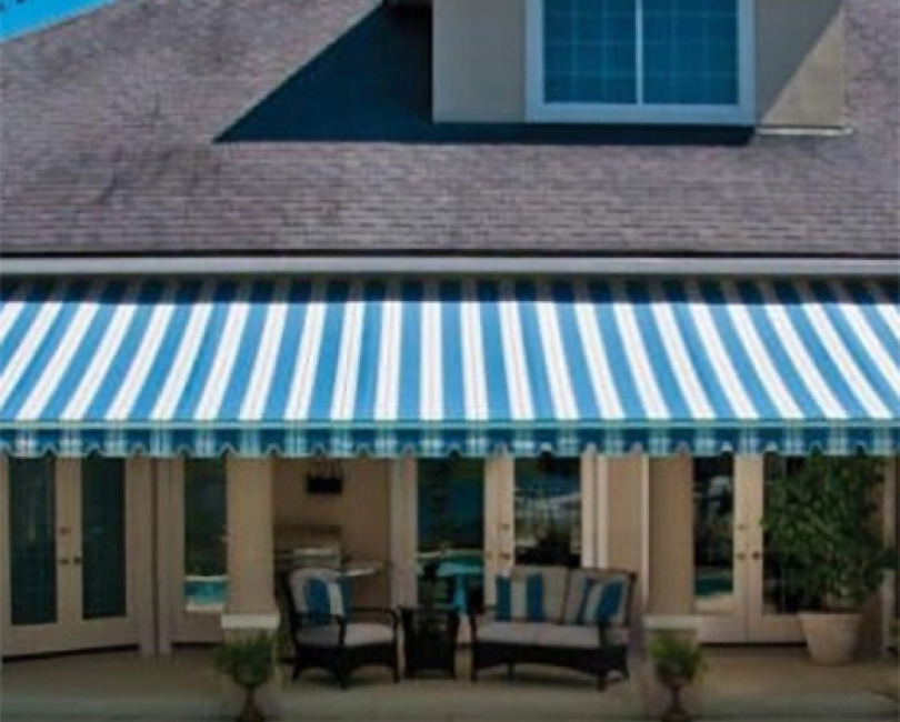 Striped retractable patio awning on a residence, Orange County
