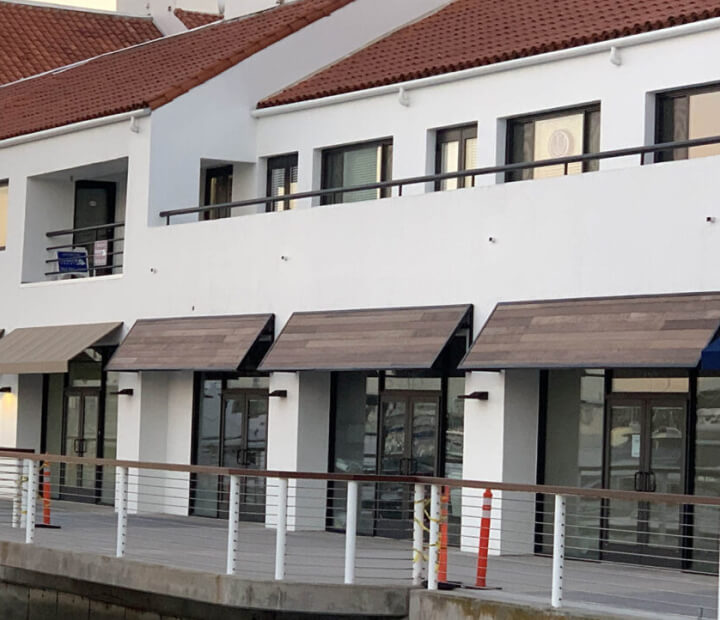 Row of wood-finish metal storefront awnings, Orange County