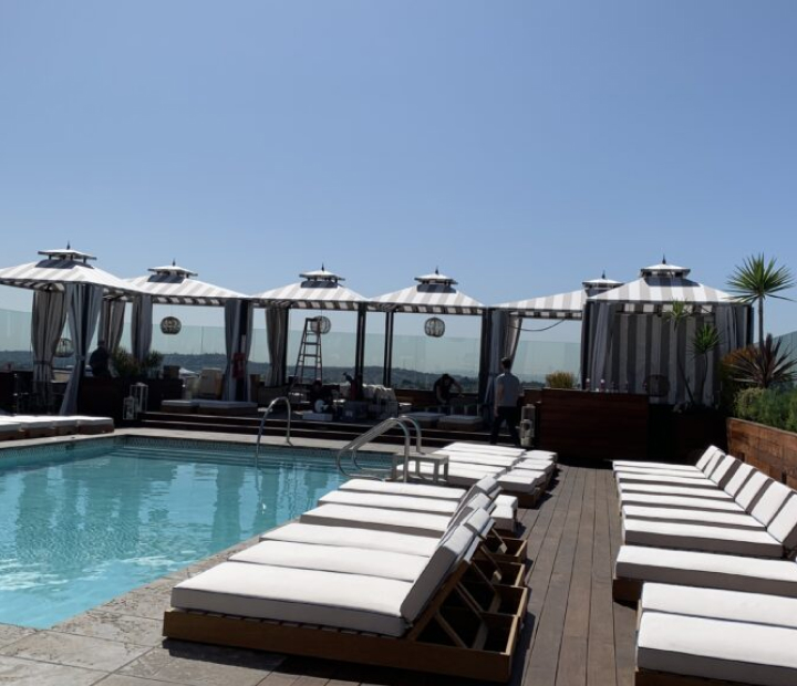 Striped poolside cabanas with lounge chairs, Ventura County