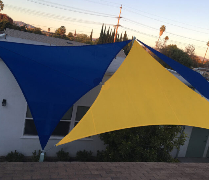 Blue and yellow shade sails above a play area, Riverside County