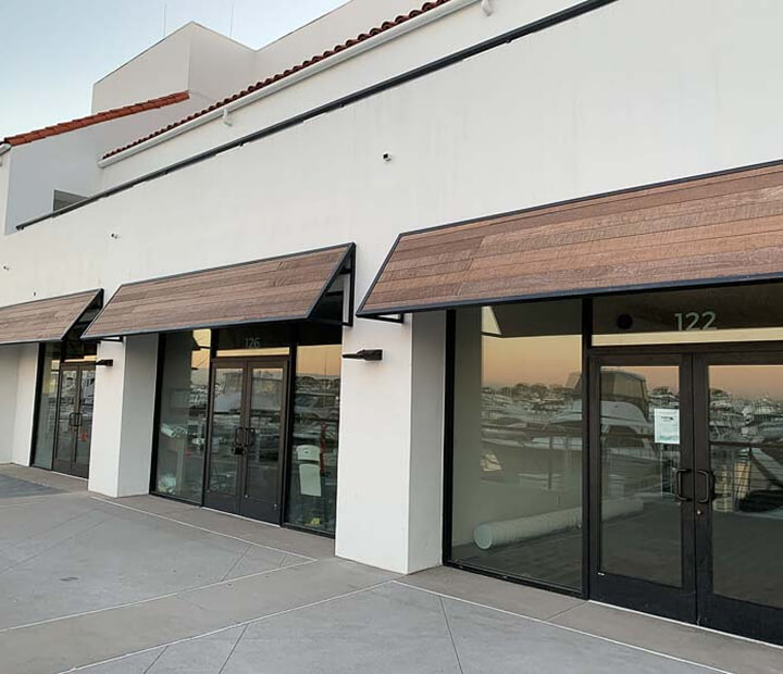 Wood-slat canopies above a modern storefront, Ventura County