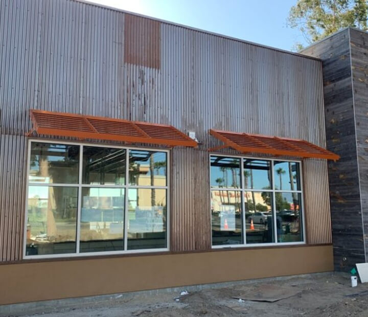 Copper-colored metal awnings on an industrial storefront, Ventura County