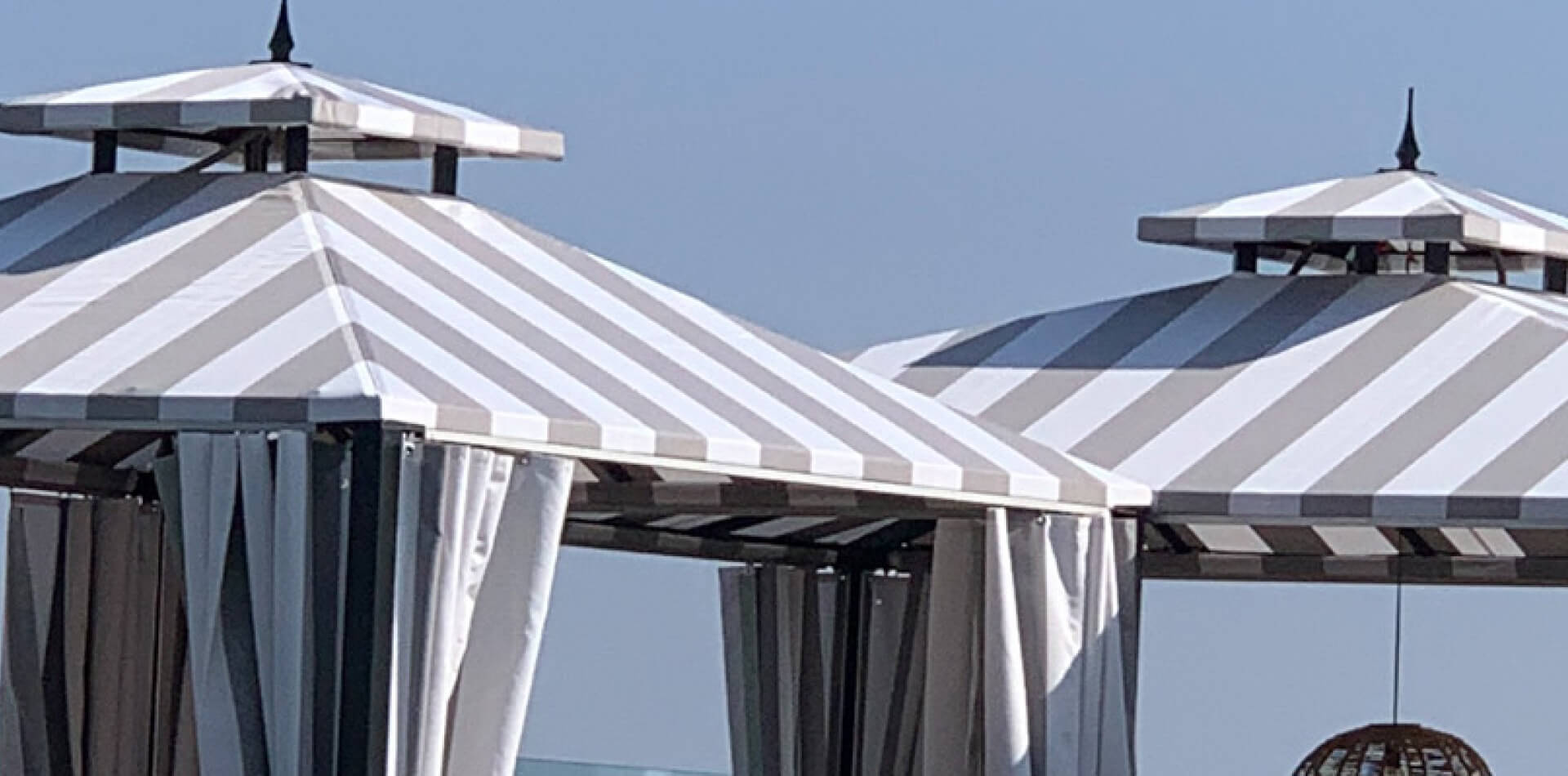 Striped fabric hotel cabanas with privacy curtains, Ventura County