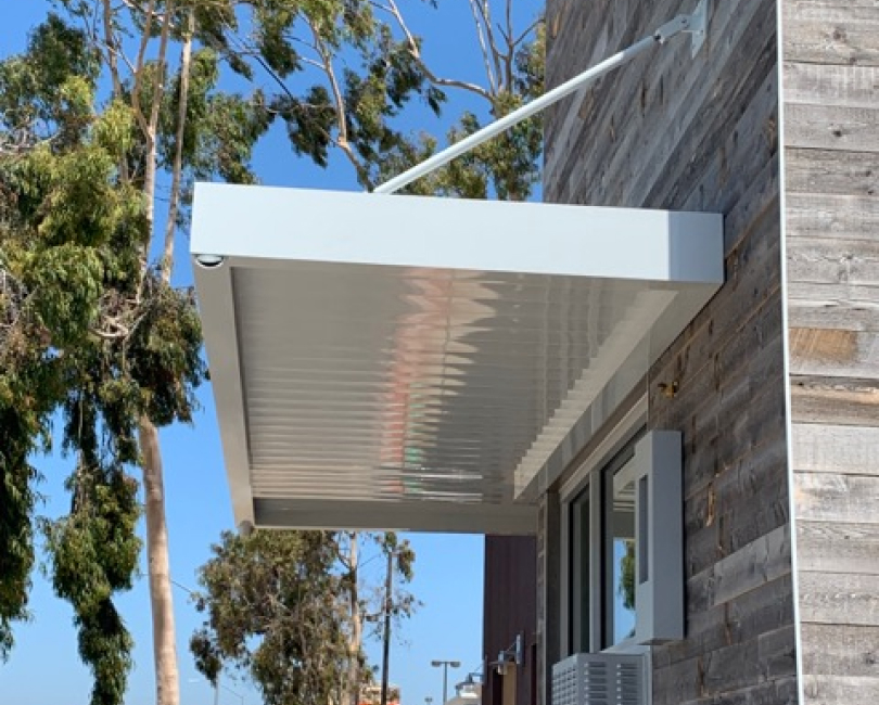 Wall-mounted white metal canopy, Orange County