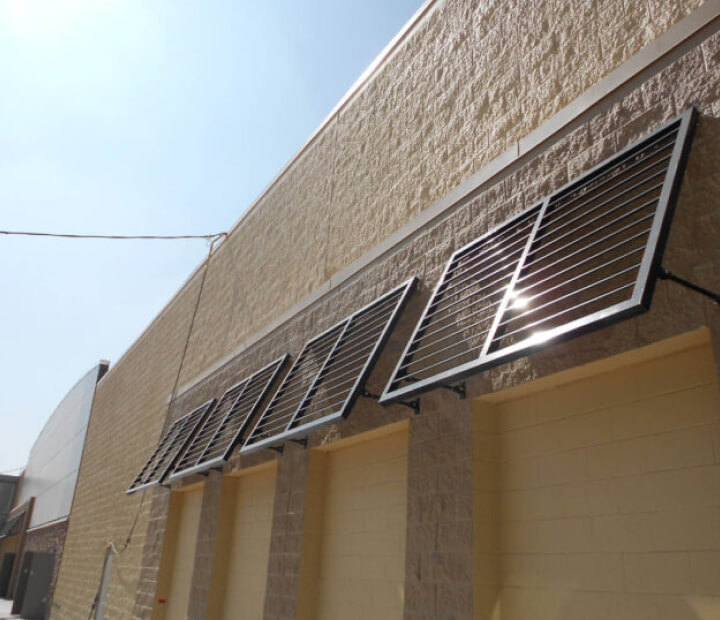 Louvered metal awnings along a commercial wall, Orange County