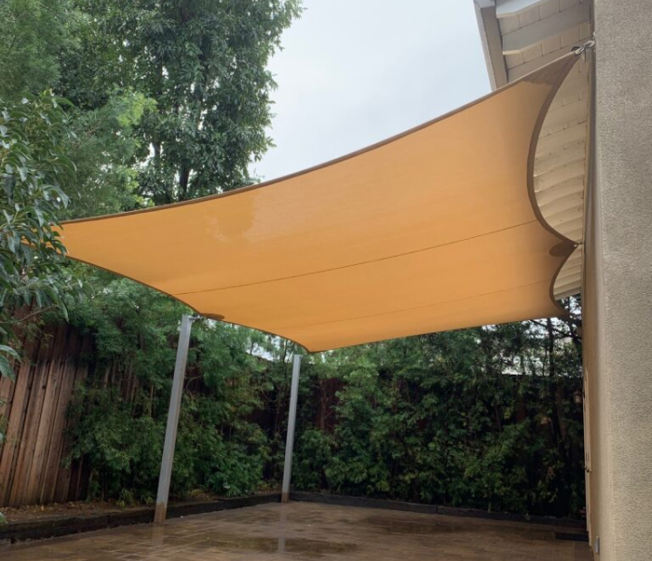 Tan shade sail over a residential patio, Riverside County