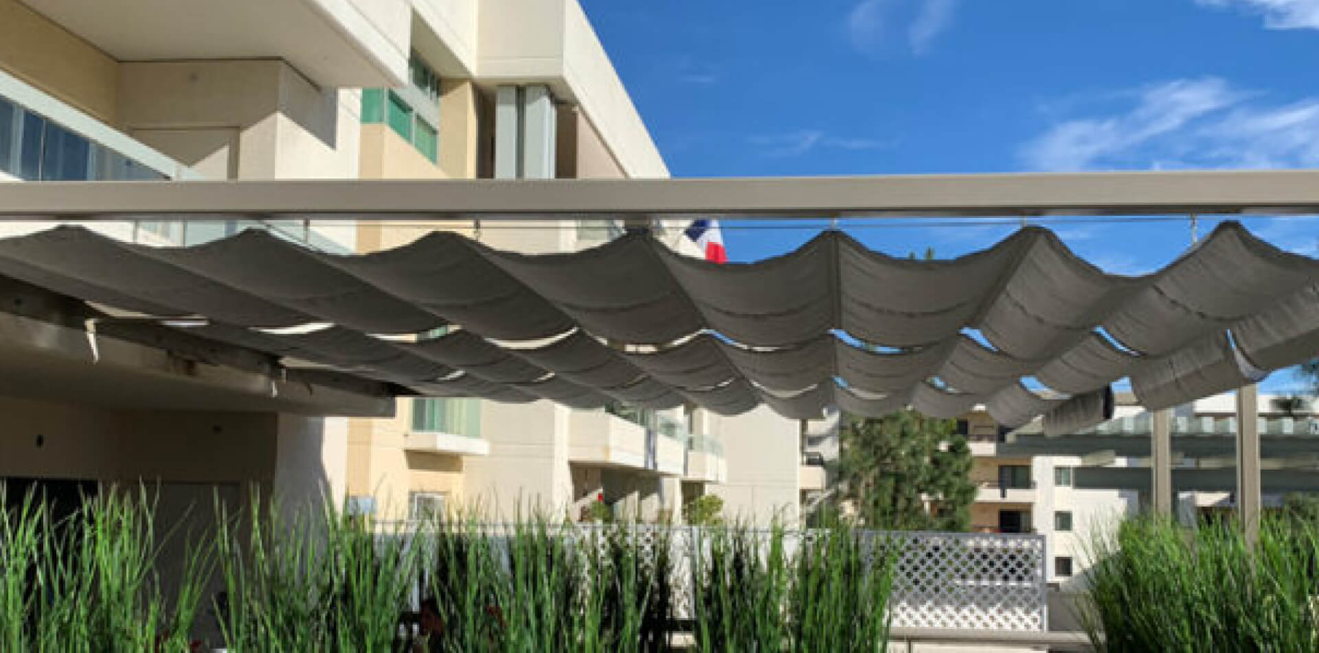 Retractable slide-on-wire canopy above a hotel patio, Los Angeles