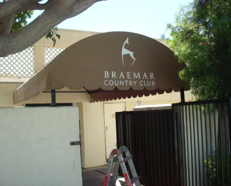 Brown entrance awning at Braemar Country Club, Los Angeles