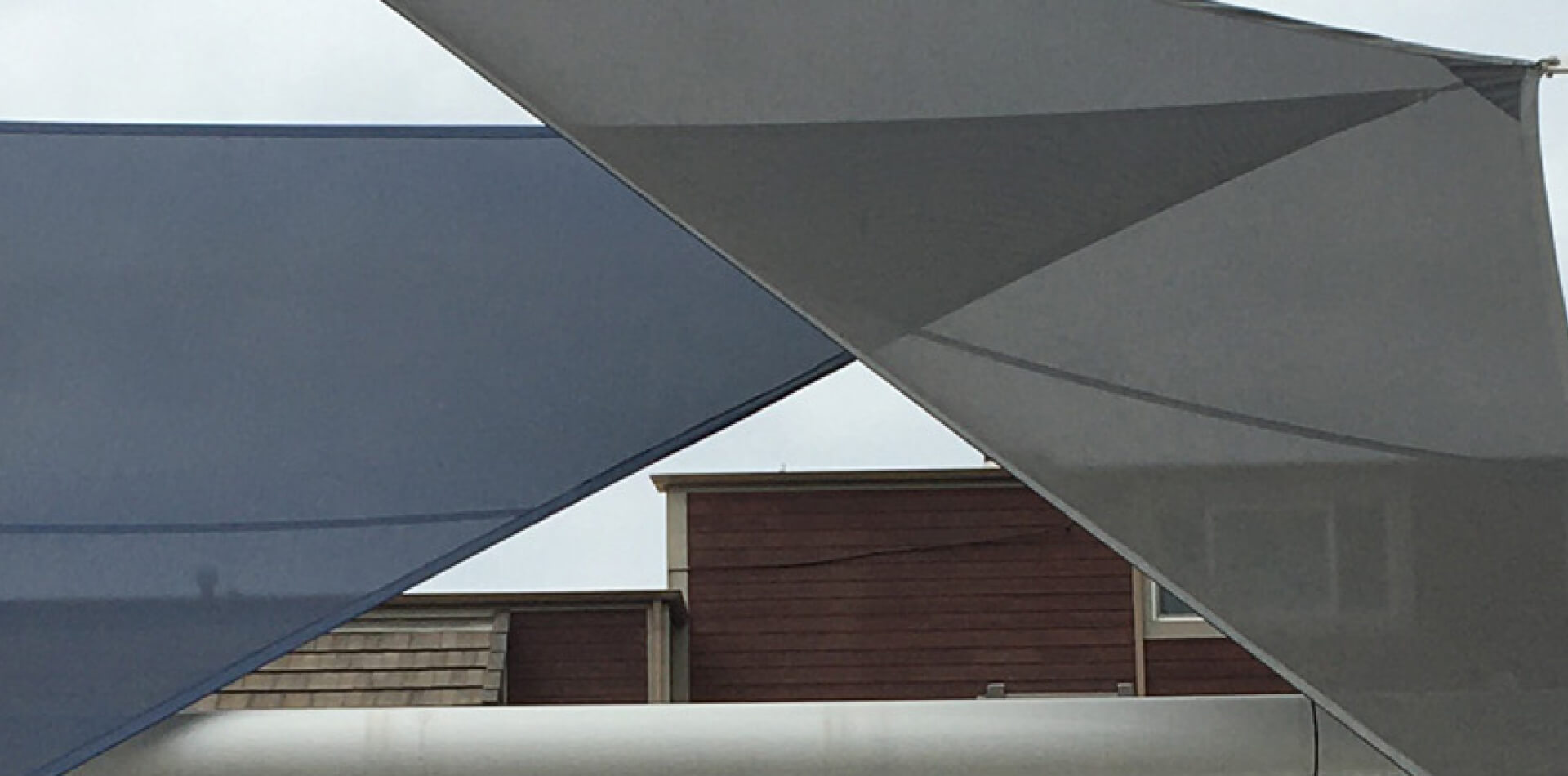 Overlapping gray tensioned shade sails, Riverside County