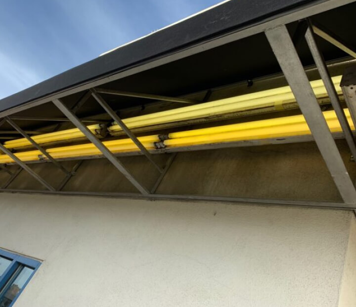 Steel framing beneath a fixed canvas awning, Los Angeles