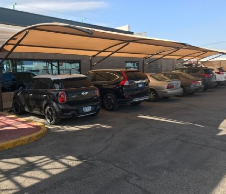 Curved fabric parking canopies over parked cars, Riverside County