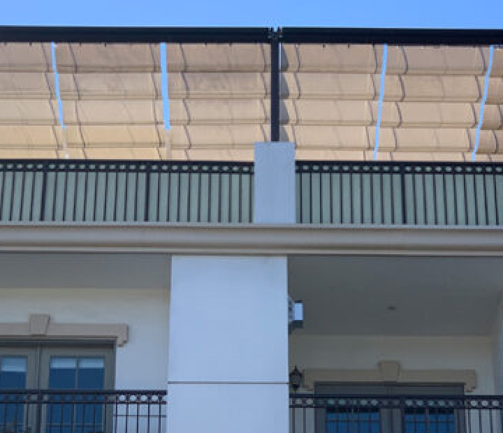White slide-on-wire canopy panels above a balcony, San Diego County