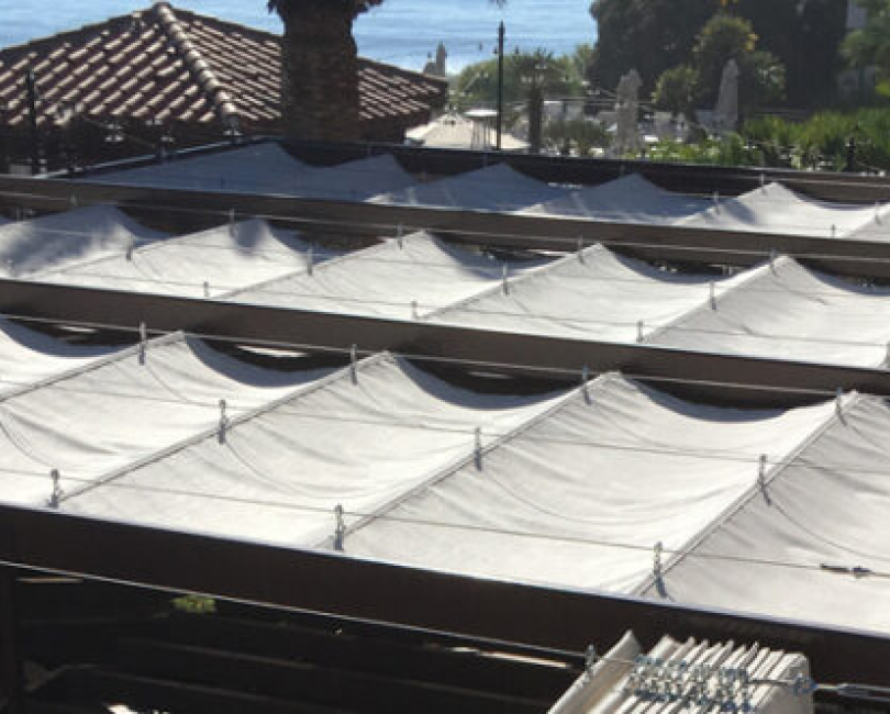 Rows of gathered slide-on-wire fabric panels, San Diego County