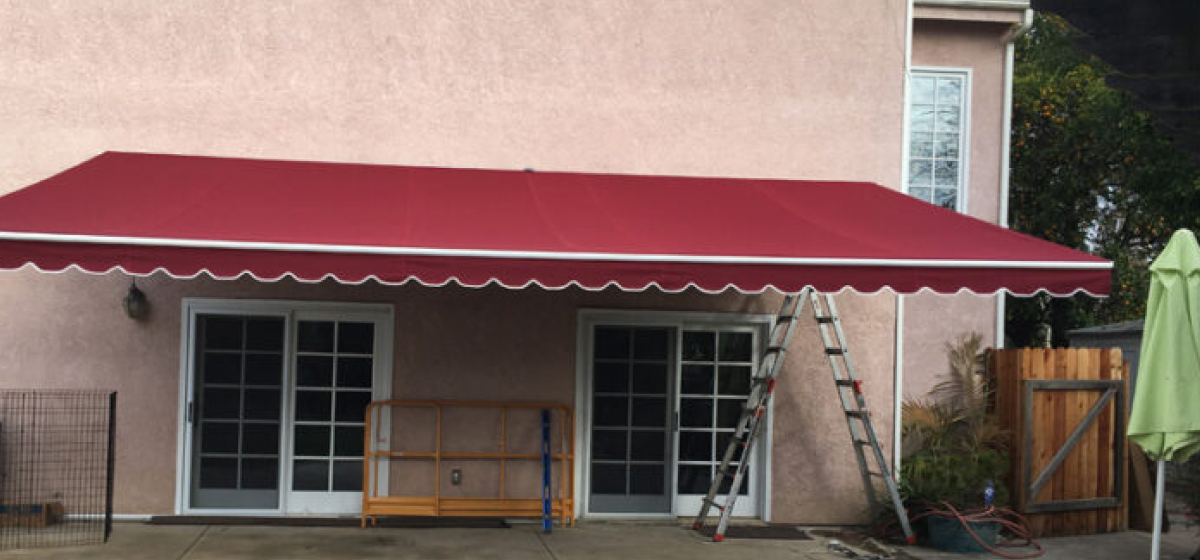 Red retractable patio awning on a residence, Orange County