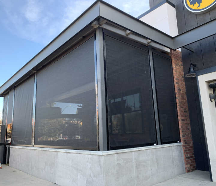 Black mesh drop-down shades on a commercial patio, Ventura County