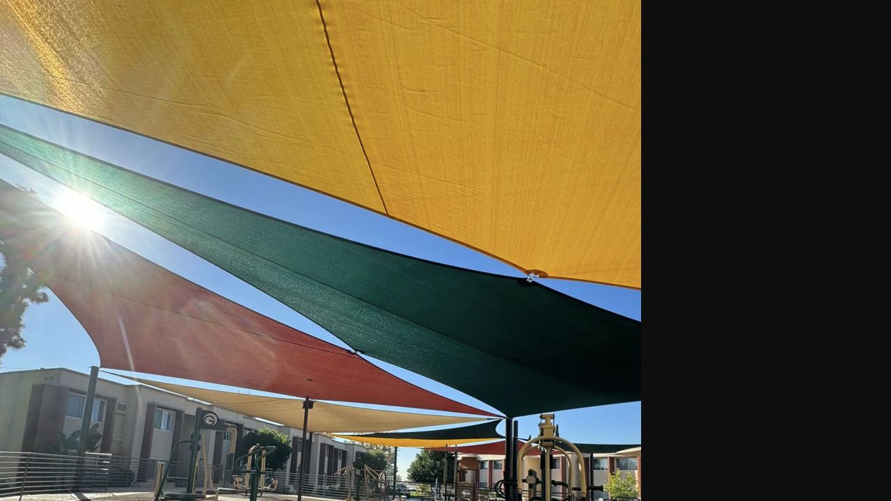 Fabric shade structure covering a playground at an apartment community in Sylmar