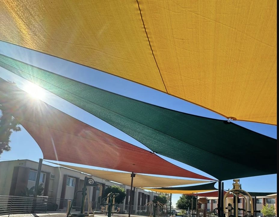 Colorful shade sails covering an apartment community playground in Sylmar