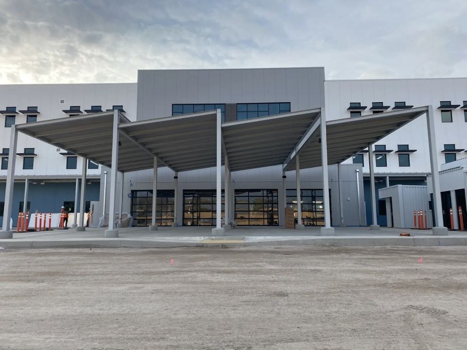 Large aluminum canopy structure at a commercial facility