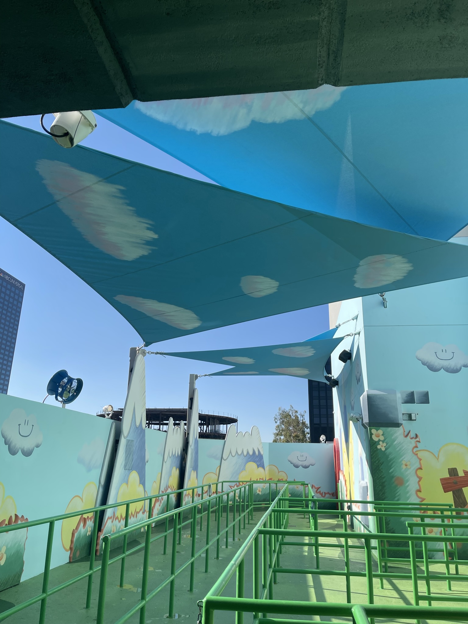 Cloud-pattern shade sails installed over the Mario Kart queue at Universal Studios Hollywood