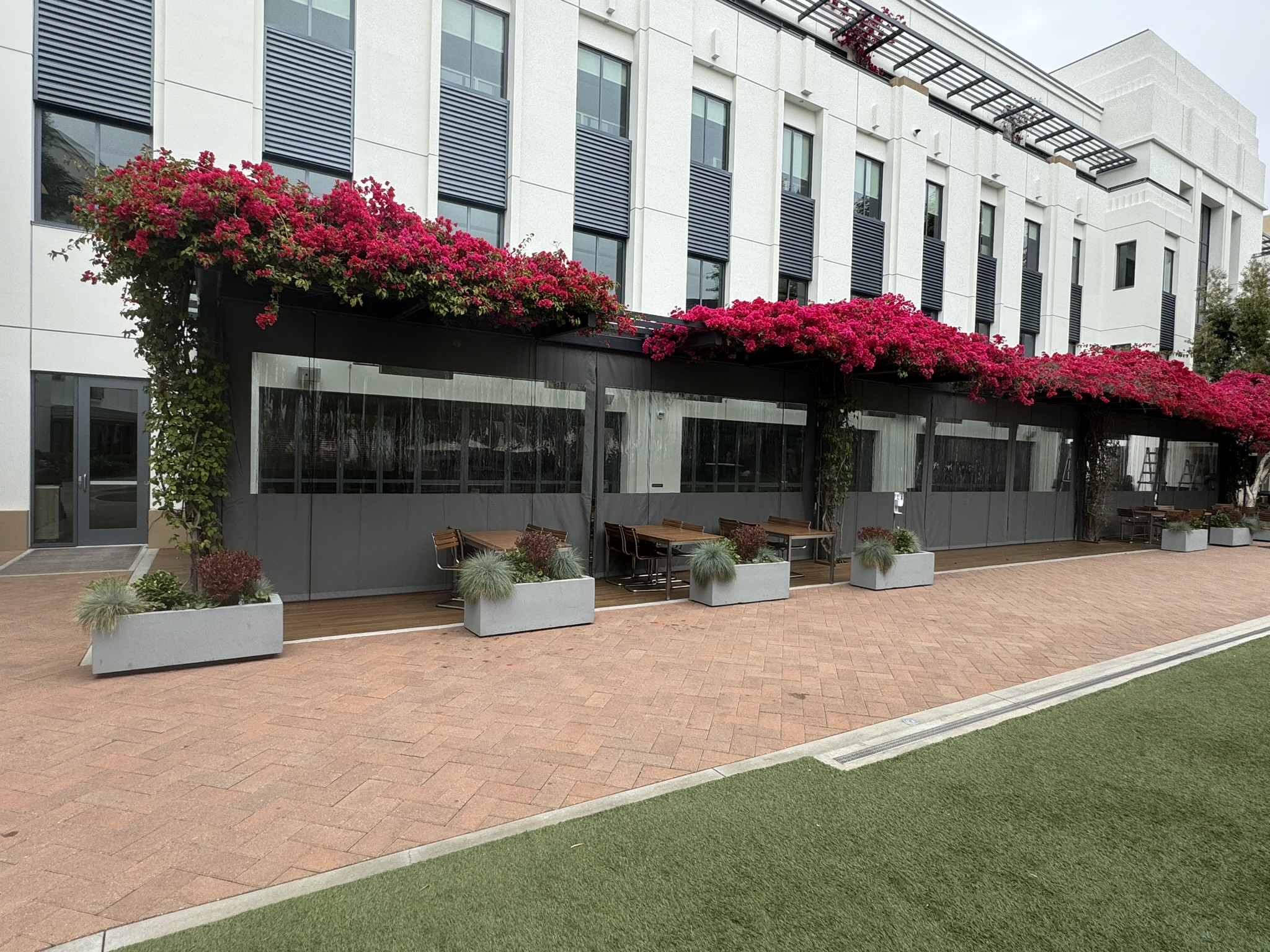Clear outdoor patio curtains enclosing a covered dining area at Sony Studios