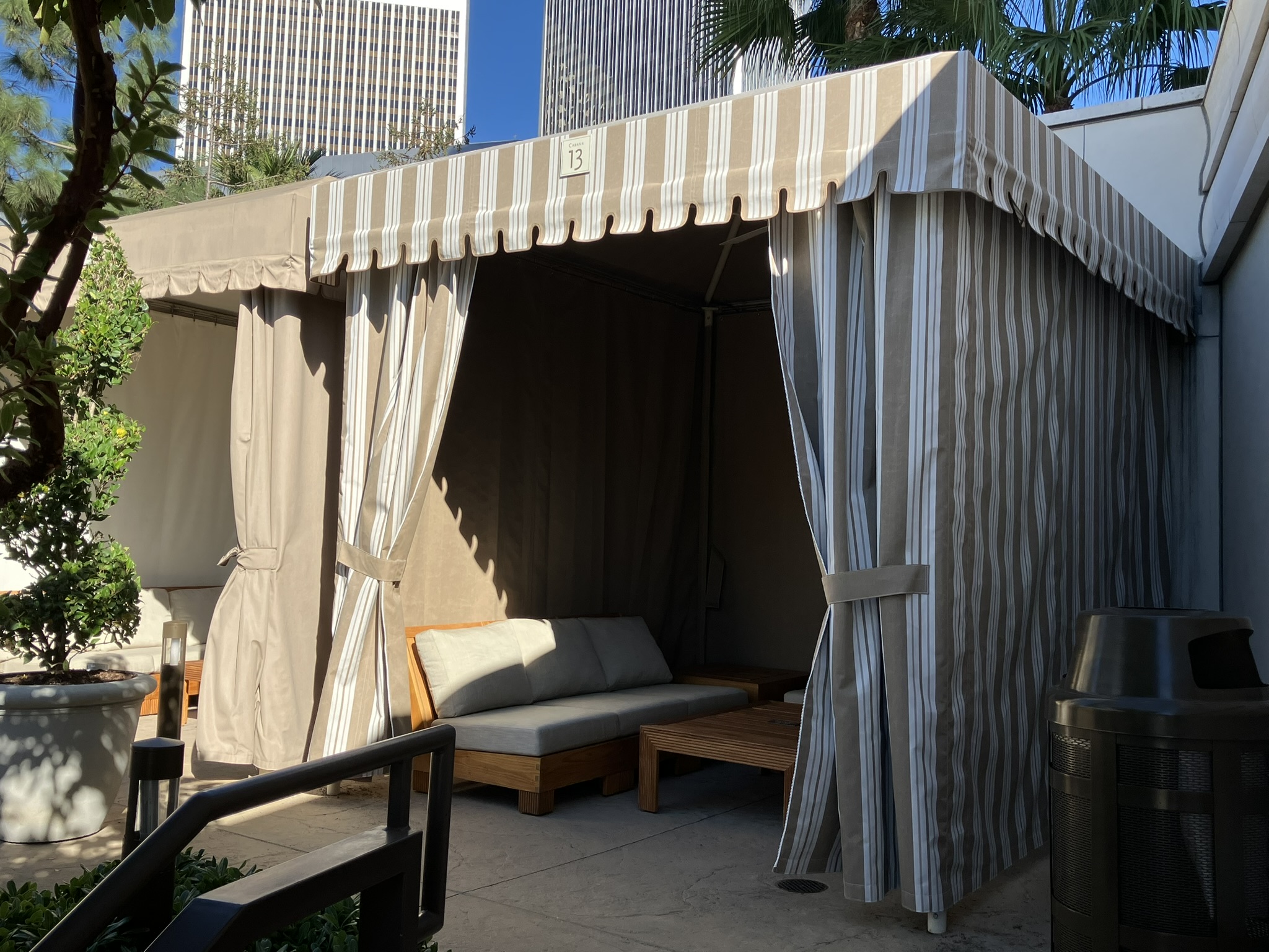 White custom cabana with fabric roof and side curtains at an event property