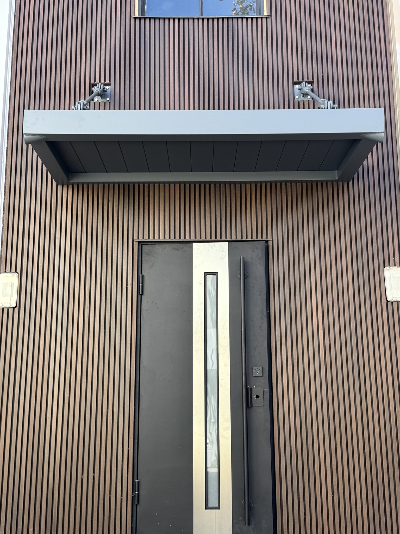 Compact aluminum canopy installed over a commercial building entrance