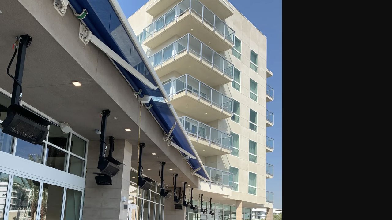 Blue retractable awnings extended over guest balconies at a Marriott hotel
