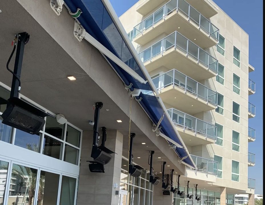 Detail view of blue retractable awnings extended over hotel balconies