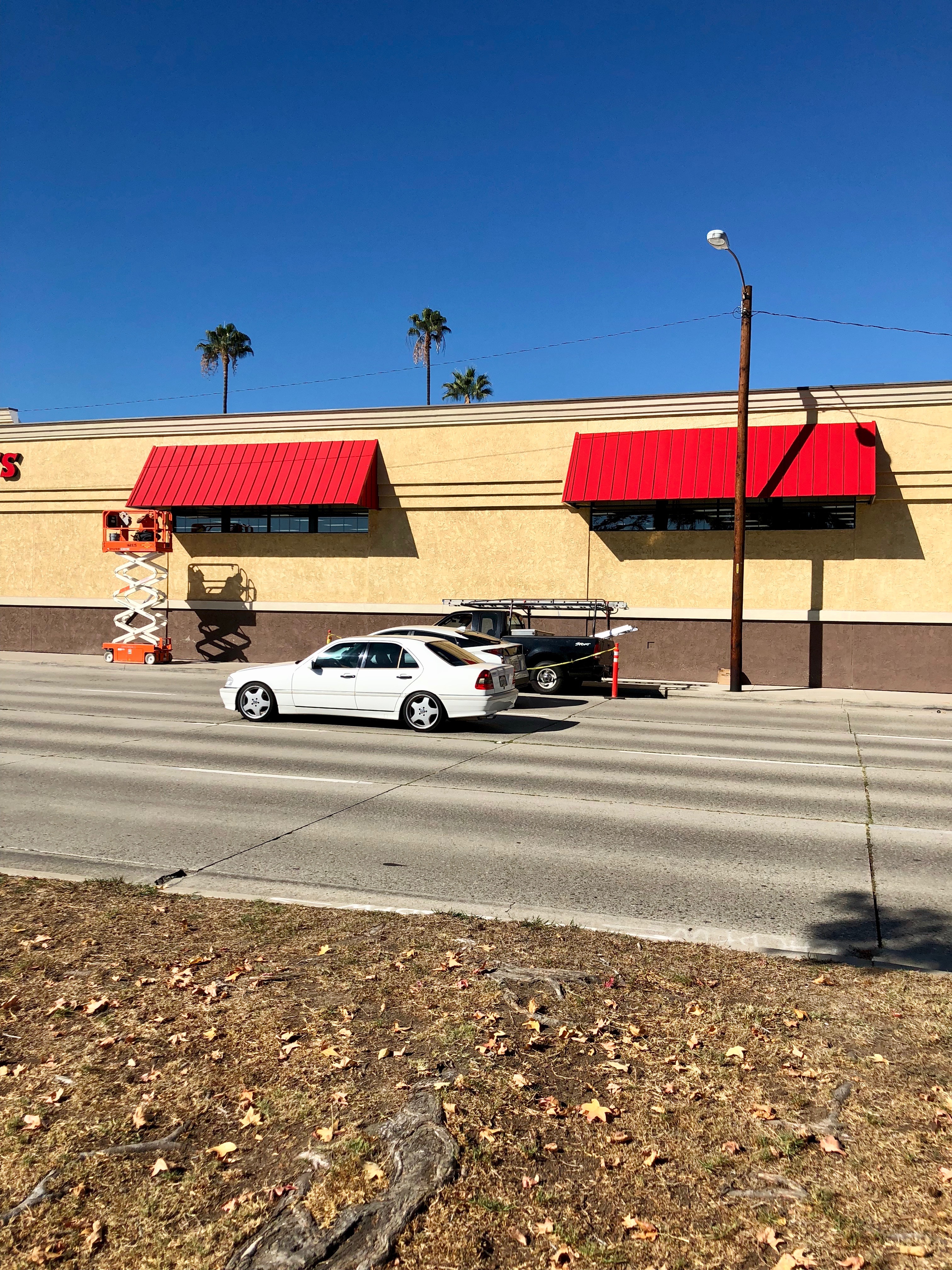 Red metal awnings installed above the service bays of a CVS commercial building