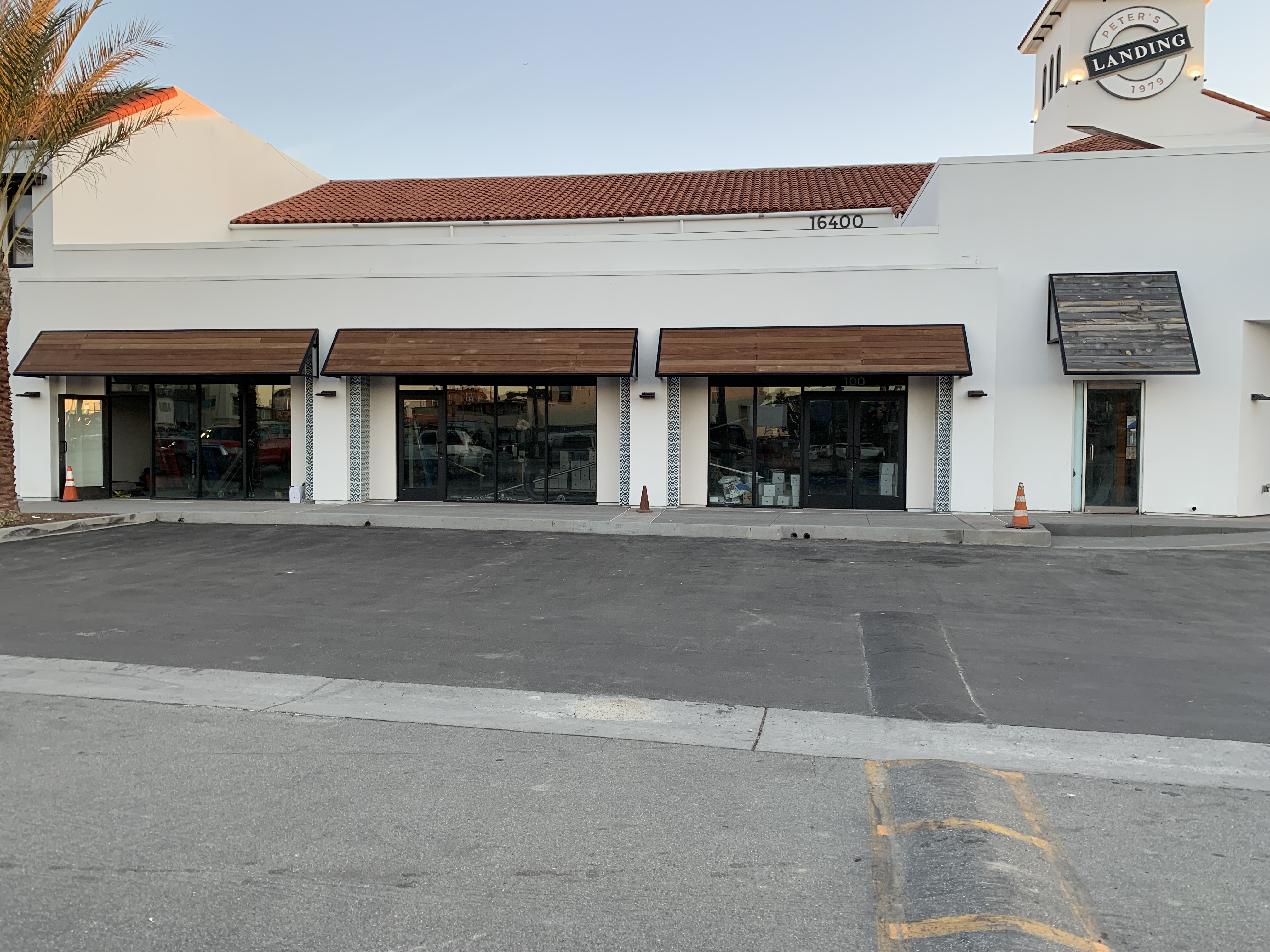 Row of custom metal awnings across the storefronts at Peter's Landing