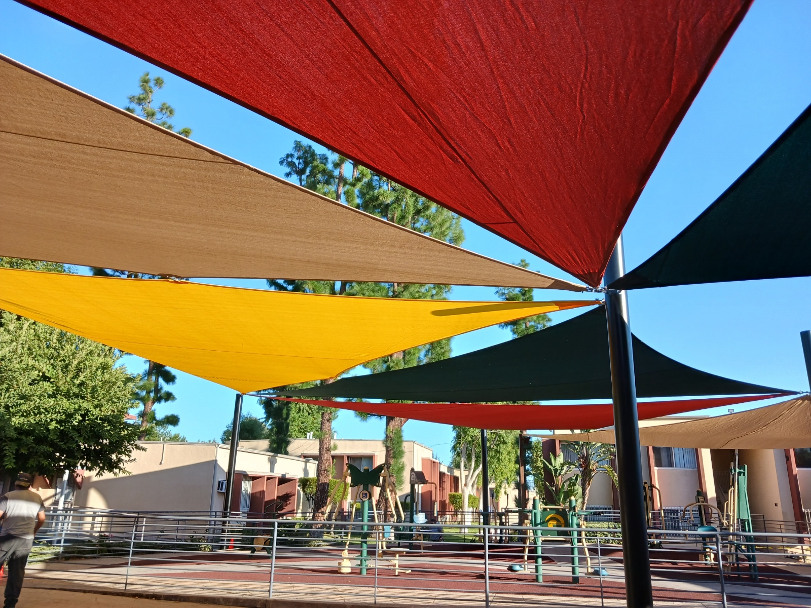 Overlapping colorful shade sails above a playground in Sylmar
