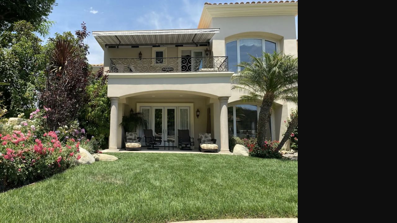 Striped retractable awning extended over a residential patio