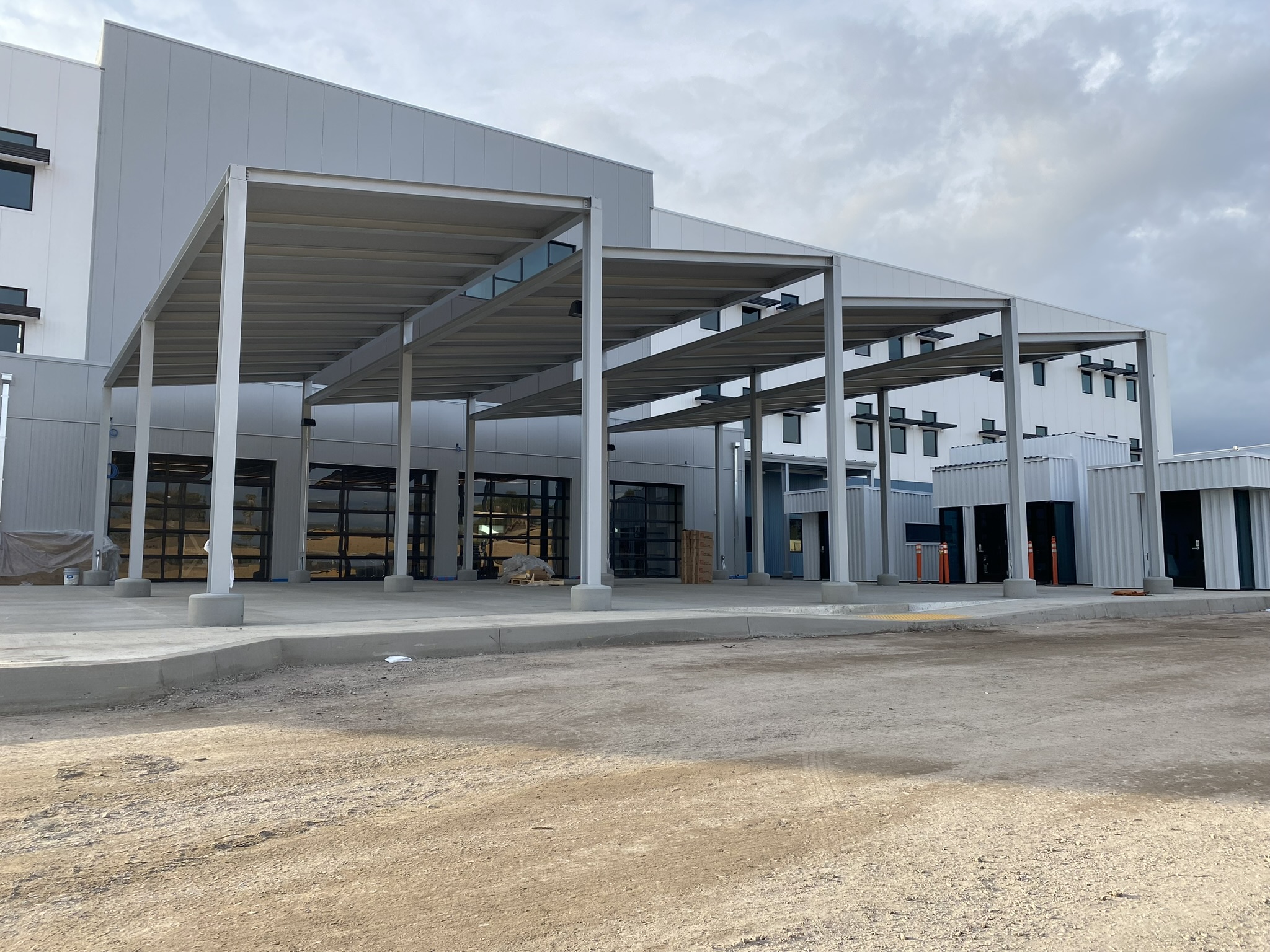 Large metal canopy structures covering commercial service bays