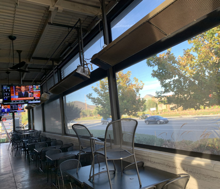 Mesh drop-down shades along an outdoor bar, Ventura County