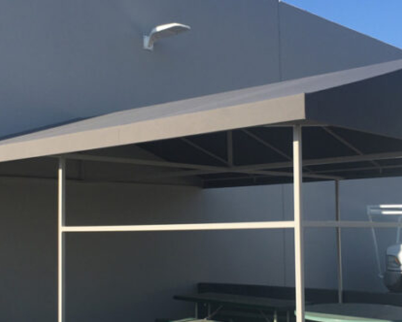 Steel frame beneath a commercial patio cover, Orange County