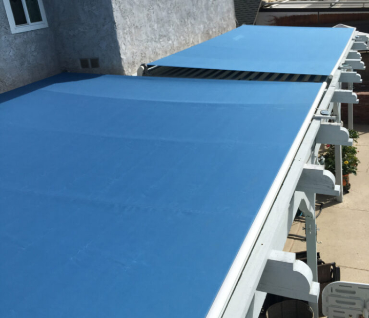 Top view of a large blue retractable awning, Orange County
