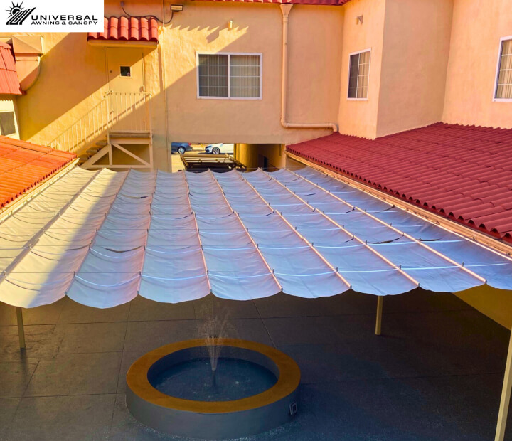 Tensioned shade sail at a hotel property, installation view